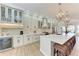 Modern kitchen with white cabinets, quartz countertops, and stainless steel appliances at 149 Montelluna Dr, North Venice, FL 34275