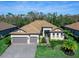 Luxury home with tile roof, 3-car garage, and landscaped yard at 16125 Tradewind Ter, Lakewood Ranch, FL 34211