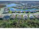 Aerial perspective showcasing a row of homes near a lake at 16125 Tradewind Ter, Lakewood Ranch, FL 34211