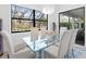 Modern dining room featuring a glass table and access to backyard at 16125 Tradewind Ter, Lakewood Ranch, FL 34211