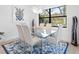 Bright dining room with glass table, light-colored chairs, and stylish rug at 16125 Tradewind Ter, Lakewood Ranch, FL 34211