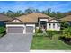 Two-story house with a three-car garage and landscaped yard at 16125 Tradewind Ter, Lakewood Ranch, FL 34211