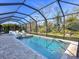 Relaxing screened pool and spa area with plenty of lounging space at 16125 Tradewind Ter, Lakewood Ranch, FL 34211