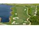 Golf course with a lake and sand traps visible from above at 17505 Opal Sand Dr # 108, Venice, FL 34293