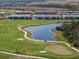 Aerial view showcasing a villa next to a golf course and lake at 17505 Opal Sand Dr # 108, Venice, FL 34293