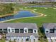 Aerial view of community featuring villas, golf course, and lake at 17505 Opal Sand Dr # 108, Venice, FL 34293