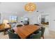 Open concept dining area showcasing a wood table and green chairs near the living room at 17505 Opal Sand Dr # 108, Venice, FL 34293