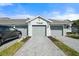 Two-car garage with driveway and landscaping at 17505 Opal Sand Dr # 108, Venice, FL 34293