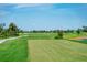 Expansive green golf course with a lake in the background at 17505 Opal Sand Dr # 108, Venice, FL 34293