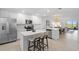 Modern kitchen with island, stainless steel appliances, and white cabinets at 17505 Opal Sand Dr # 108, Venice, FL 34293