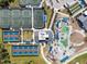 Aerial view of resort-style pool and tennis/pickleball courts at 17505 Opal Sand Dr # 108, Venice, FL 34293