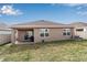 House exterior and backyard view with grassy lawn at 17741 Canopy Pl, Bradenton, FL 34211