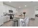 Modern kitchen with island, white cabinets, and granite counters at 17741 Canopy Pl, Bradenton, FL 34211