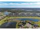 Wide aerial view of community, golf course, and lake at 18017 Gawthrop Dr # 101, Bradenton, FL 34211