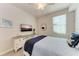 Bright bedroom with a queen bed, TV, and coastal decor at 18017 Gawthrop Dr # 101, Bradenton, FL 34211