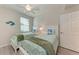 Bedroom with twin beds, ceiling fan and light, blue and green decor at 18017 Gawthrop Dr # 101, Bradenton, FL 34211