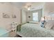 Bedroom with twin beds, ceiling fan and light, coastal decor at 18017 Gawthrop Dr # 101, Bradenton, FL 34211