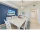 Bright dining room with a white table and blue accent wall at 18017 Gawthrop Dr # 101, Bradenton, FL 34211