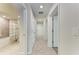 Bright hallway with tile flooring and multiple doors leading to bedrooms and a bathroom at 18017 Gawthrop Dr # 101, Bradenton, FL 34211