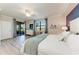 Large main bedroom with a king-size bed and access to a balcony at 18017 Gawthrop Dr # 101, Bradenton, FL 34211