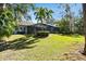 Expansive backyard offering a lush lawn and screened enclosure at 1854 Amberwynd W Cir, Palmetto, FL 34221