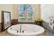 Oval bathtub with window and tile surround at 1854 Amberwynd W Cir, Palmetto, FL 34221