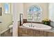 Oval bathtub with window and tile surround at 1854 Amberwynd W Cir, Palmetto, FL 34221