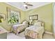 Guest bedroom with two twin beds and large window at 1854 Amberwynd W Cir, Palmetto, FL 34221