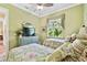 Bright guest bedroom with two twin beds and garden view at 1854 Amberwynd W Cir, Palmetto, FL 34221