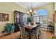 Dining room with hardwood floors, a china cabinet, and a chandelier at 1854 Amberwynd W Cir, Palmetto, FL 34221