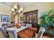 Elegant dining room with a wooden table and gray chairs, and a large window at 1854 Amberwynd W Cir, Palmetto, FL 34221