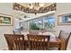 Bright dining room with a wooden table and chairs, featuring a decorative chandelier and artwork at 1854 Amberwynd W Cir, Palmetto, FL 34221