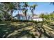 House exterior showcasing a manicured lawn and palm trees at 1854 Amberwynd W Cir, Palmetto, FL 34221