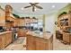 Bright kitchen featuring granite island, stainless steel appliances, and wood cabinetry at 1854 Amberwynd W Cir, Palmetto, FL 34221