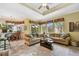 Living area with beige sofas, a coffee table, and views to a patio at 1854 Amberwynd W Cir, Palmetto, FL 34221