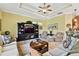 Living room with neutral colored sofas, a large TV, and a wooden coffee table at 1854 Amberwynd W Cir, Palmetto, FL 34221