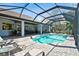 Expansive pool and patio with screened enclosure, offering ample space for relaxation at 1854 Amberwynd W Cir, Palmetto, FL 34221