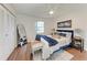 Main bedroom with a blue bed and wood flooring at 20032 Sancraft Ave, Port Charlotte, FL 33954