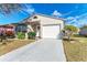 Single story house with a white garage door and well-manicured lawn at 20032 Sancraft Ave, Port Charlotte, FL 33954