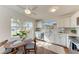 Modern kitchen with white cabinets, stainless steel appliances, and a breakfast nook at 20032 Sancraft Ave, Port Charlotte, FL 33954