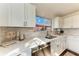 Renovated kitchen with white cabinets, quartz countertops and tile backsplash at 20032 Sancraft Ave, Port Charlotte, FL 33954