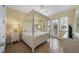 Main bedroom with a four-poster bed and TV at 203 69Th St # A, Bradenton Beach, FL 34217