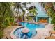 Inviting pool with patio and tropical landscaping at 203 69Th St # A, Bradenton Beach, FL 34217