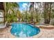 Freeform pool and spa with a tranquil waterfall feature at 203 69Th St # A, Bradenton Beach, FL 34217