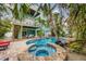 Relaxing spa and freeform pool surrounded by tropical landscaping at 203 69Th St # A, Bradenton Beach, FL 34217