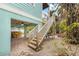 White wooden staircase leading to a patio with pool view at 203 69Th St # A, Bradenton Beach, FL 34217