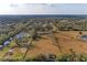 Aerial view of a home on a large lot with surrounding trees and open fields at 2119 Zipperer Rd, Bradenton, FL 34212