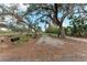 Long driveway leading to a home with large oak trees at 2119 Zipperer Rd, Bradenton, FL 34212