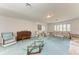 Living room with light blue carpet, sofas, and glass coffee table at 2119 Zipperer Rd, Bradenton, FL 34212