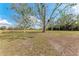 Spacious grassy pasture with mature trees and a wooden fence at 2119 Zipperer Rd, Bradenton, FL 34212